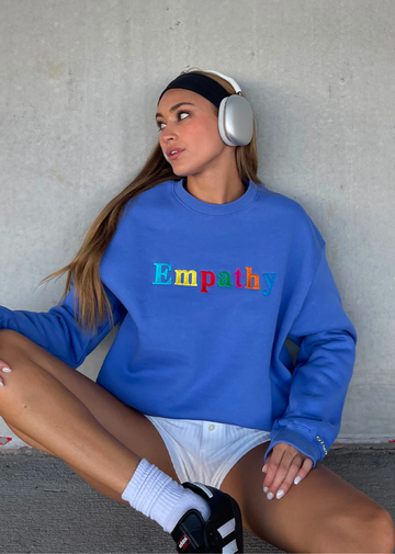 Mayfair Empathy Always crewneck sweatshirt, oversized fit, rainbow empathy letters across chest, cobalt blue