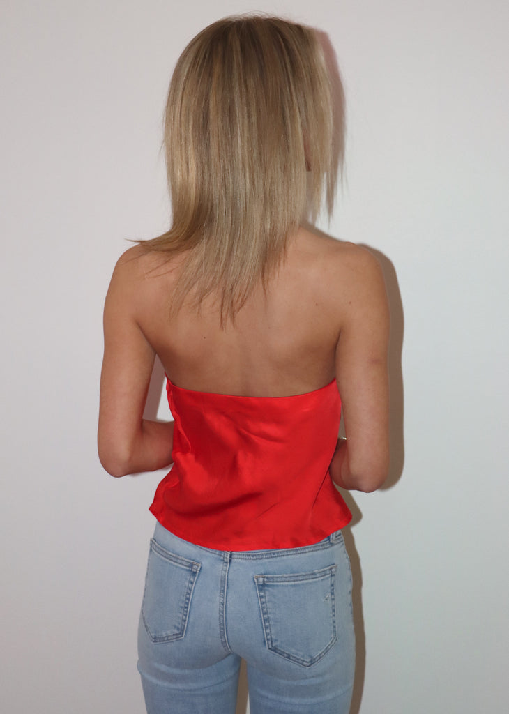 Red strapless top, loose fit. 