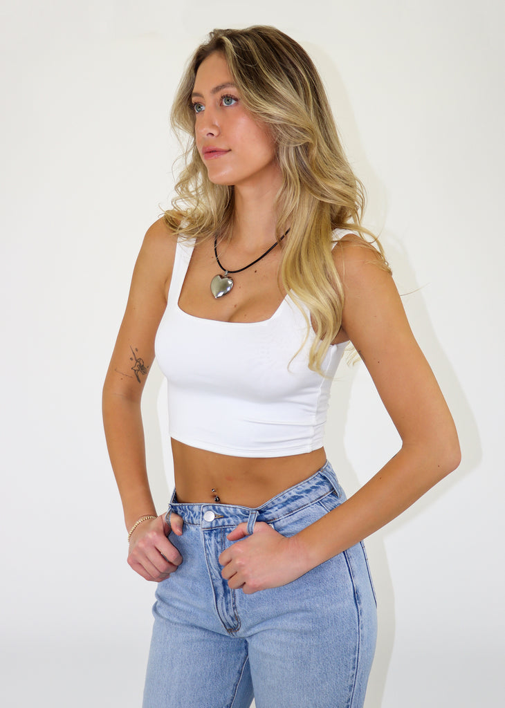 Women's seamless white cropped tank top with a square neckline.