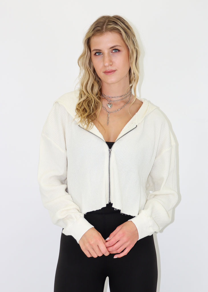 White cropped zip-up hoodie. Waffle thermal material. Cut off hem.