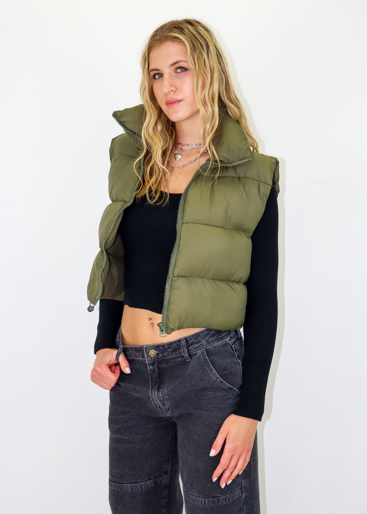 Olive green puffer vest. Zip-up front enclosure. Cropped fit.