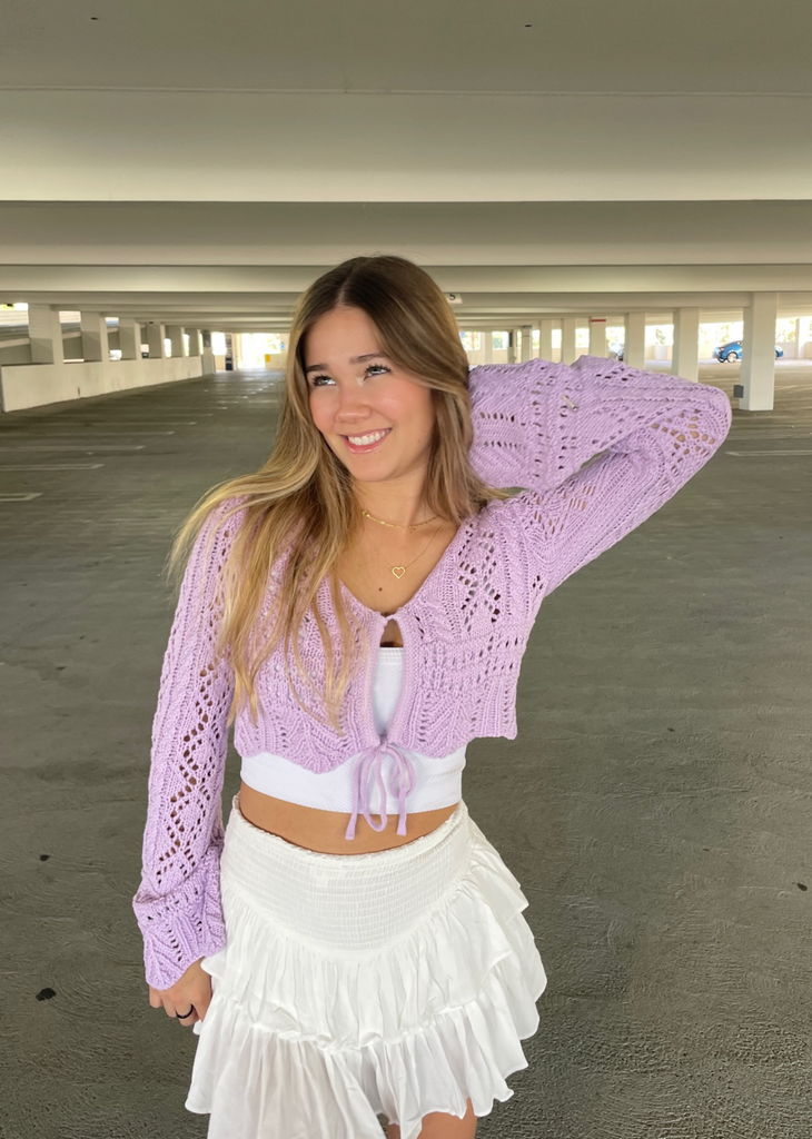Women's lavender crochet cropped cardigan sweater with keyhole tie front and bell sleeves.