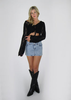 Mini skirt with distressed light wash denim material, pockets in the front and back.