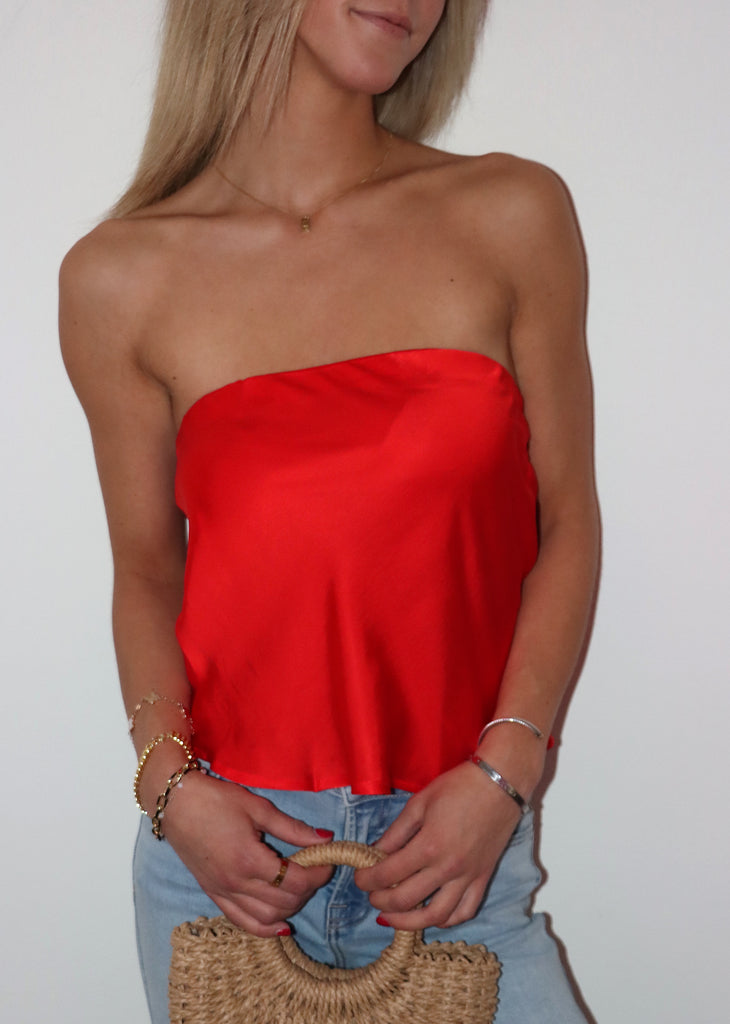 Red strapless top, loose fit. 