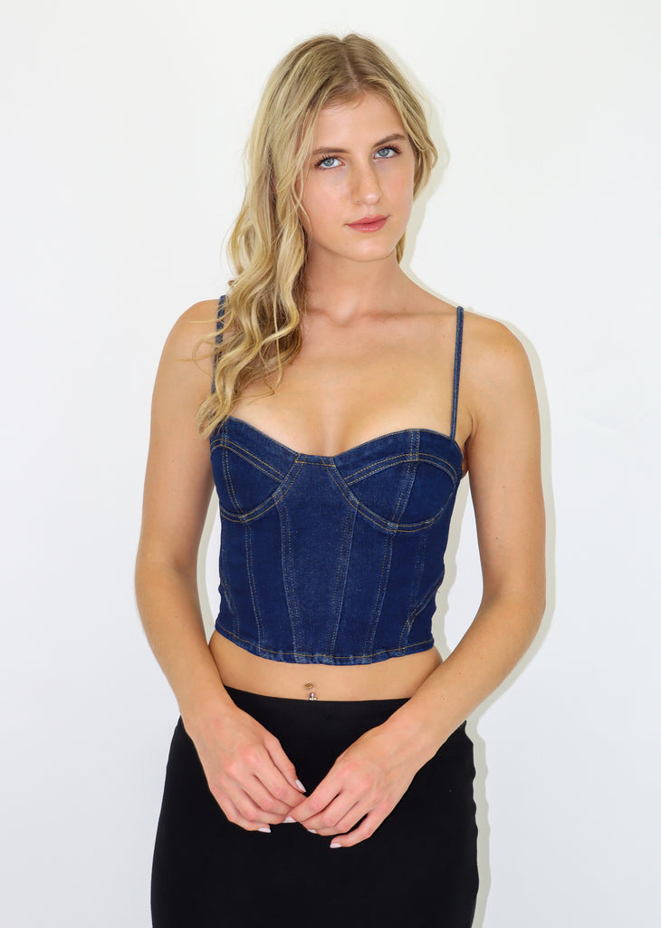 Corset top with lace up back, adjustable ties and a denim material.
