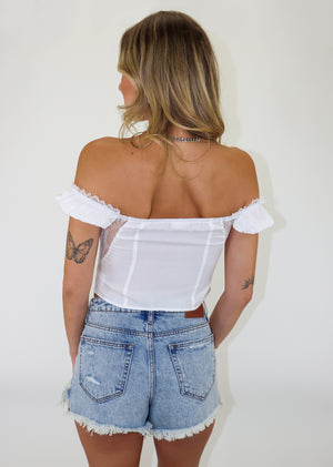 white bustier bra corset style top lace sides short sleeves off the shoulder hook and eye closure on front lace trim on sleeves and bra cropped length going out top spring summer neutral women's clothing