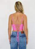 Pink corset top. Fully lined lace overlay. Lace up back adjustable straps. Curved front hem.