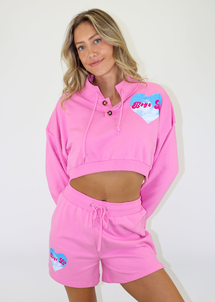 boys lie pink left side heart graphic with boys lie font and blue sky with clouds cropped fit henley style brown buttons drawstring neckline lightweight fleece fabric ribbed cuffs and hem comfy athleisure loungewear sweatshirt women's clothing
