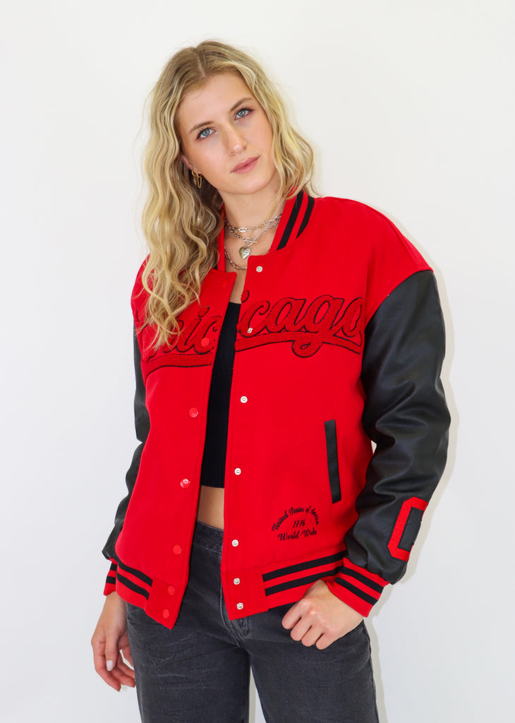 Varsity bomber jacket. Faux leather sleeves, embroidered lettering. Front button closures. Front pockets, quilted lining.