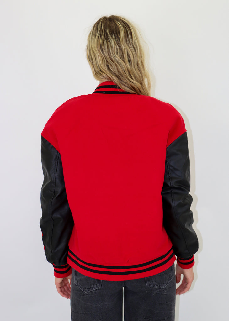 Varsity bomber jacket. Faux leather sleeves, embroidered lettering. Front button closures. Front pockets, quilted lining.
