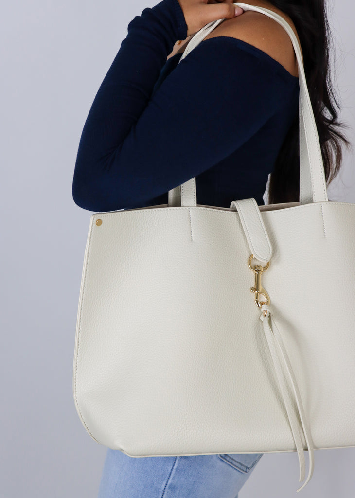 Cream leather tote bag with keychain detail and outside pocket