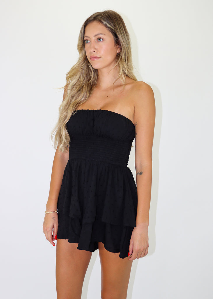 Black strapless romper featuring Dobby Dot Print, Smocked Waist and Tiered Bottom.