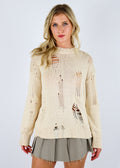 Oversized cream colored sweater, featuring a distressed knit.
