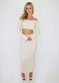 Cropped cream long sleeved knit sweater with thumb hole sleeves.
