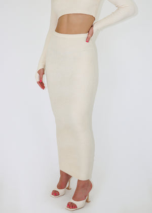 White maxi skirt, long and form-fitting.