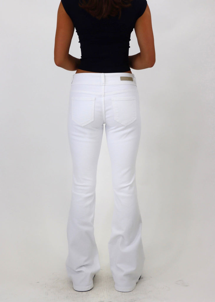 low rise white flare jeans with button detailing 