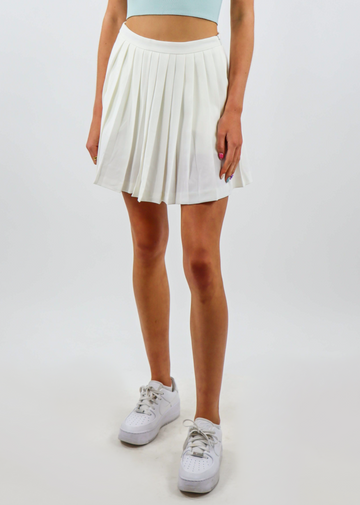 white mini tennis skirt with pleating throughout the body and invisible zipper