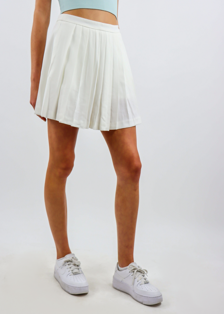 white mini tennis skirt with pleating throughout the body and invisible zipper