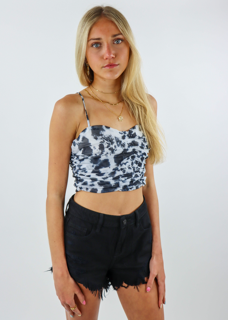 black and white spotted crop top with a ruched and cinched bodice and spaghetti straps 