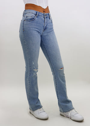 low rise bootcut light wash jeans with distressed bottoms