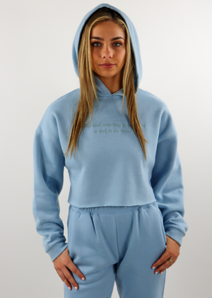 Light Blue Baby Blue Comfy Cozy Soft Cropped Hoodie with Embroidered Logo on Right Wrist and the Quote "We all need something to believe in so look in the mirror" Embroidered on the Front Center. 