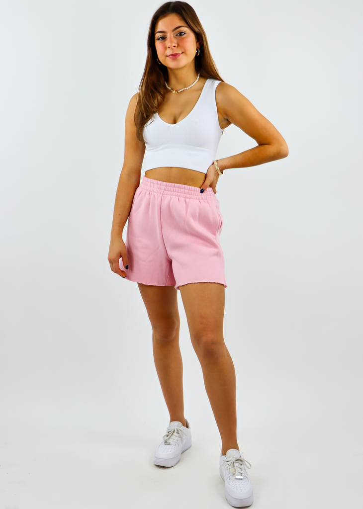 light pink sweat shorts with two front pockets and an elastic waistline