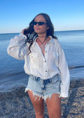 white linen relaxed fit long sleeve button up top raw edge detail two front pockets beach pool cover up casual blouse spring summer winter fall women's clothing